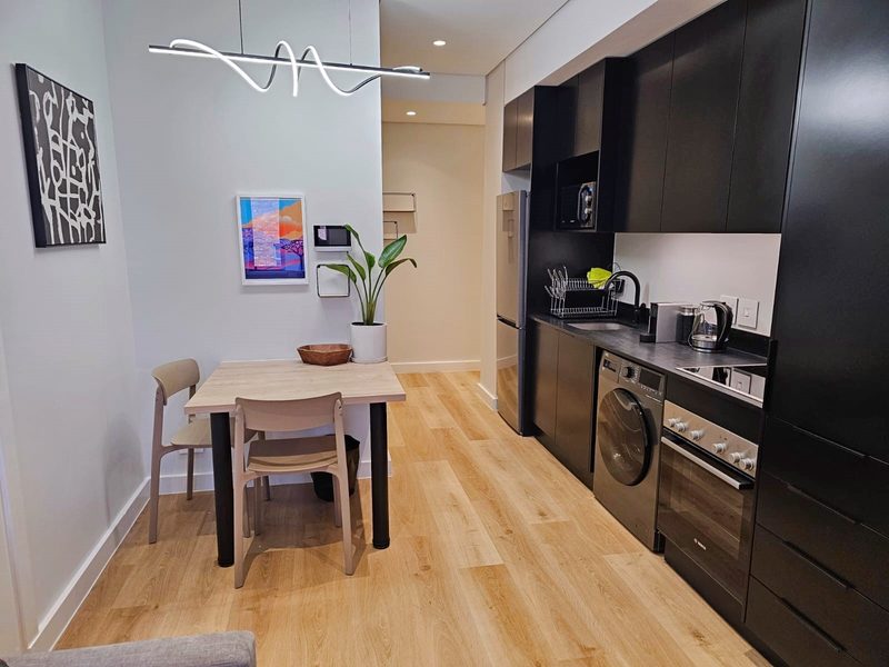 The dining table and kitchen at The Carrington