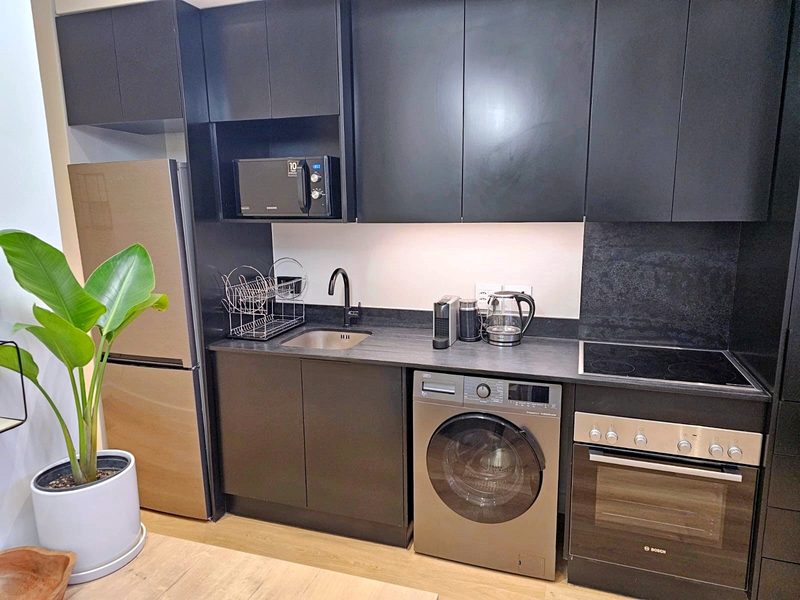 The kitchen at The Carrington, with the washer and dryer