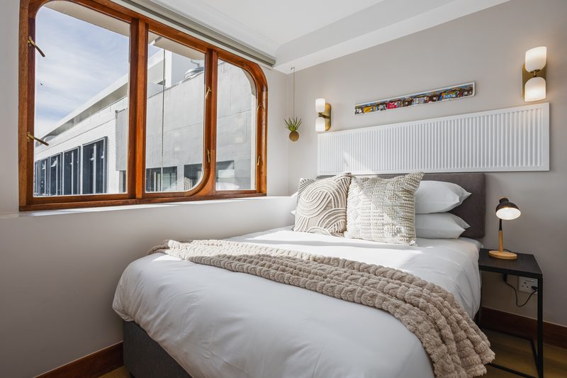 The bed at Charlie and the Chairman, under the arched window