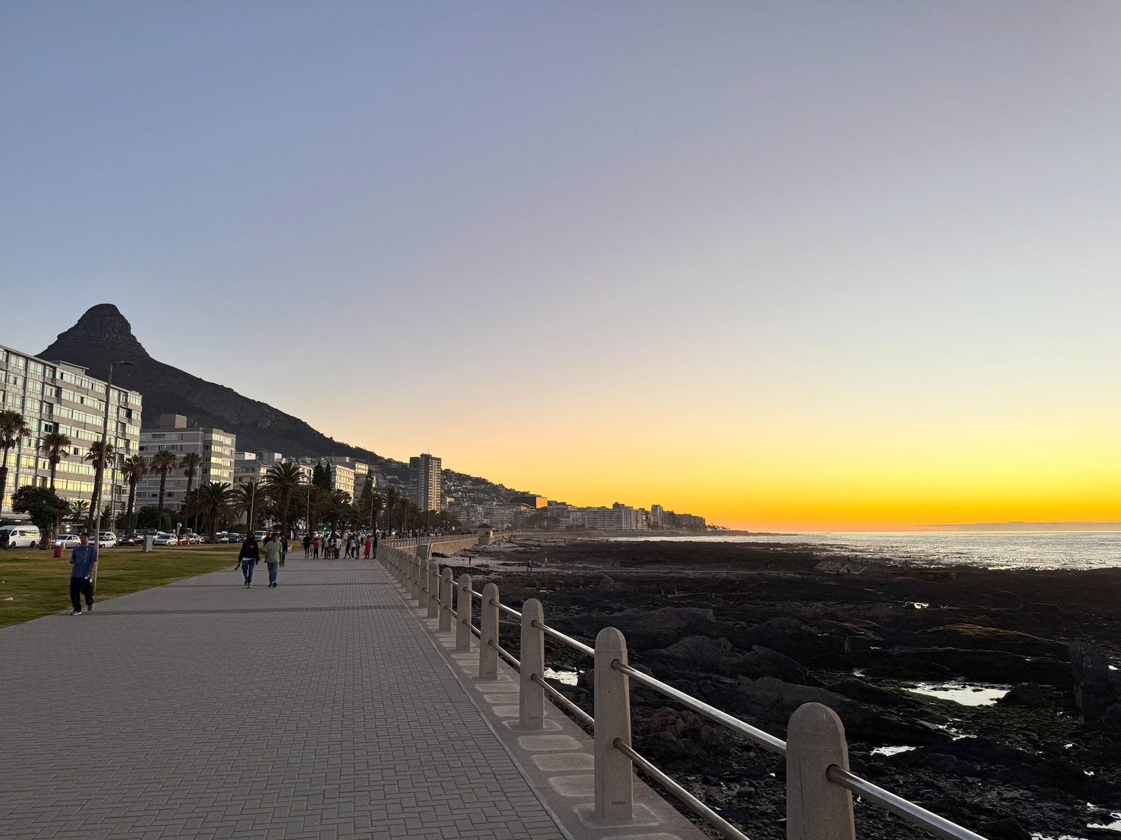 The Sea Point Promenade at sunset, with Lion&rsquo;s Head behind