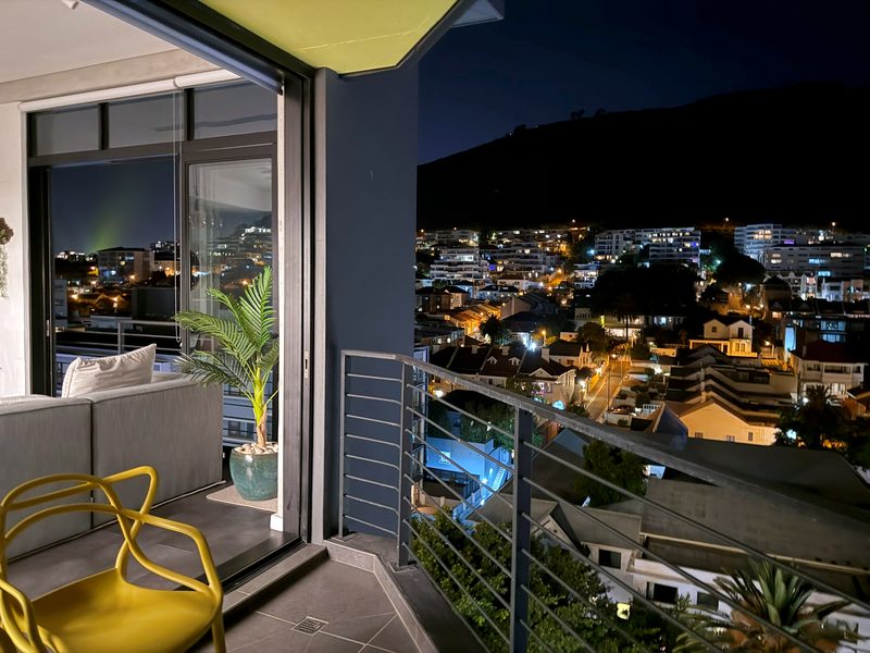 The balcony at One26 on M at night, over the lights of Sea Point